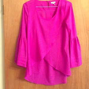 Flowy fuscia top with bell sleeves.