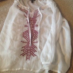 Cute white sheer long sleeve shirt with designs.