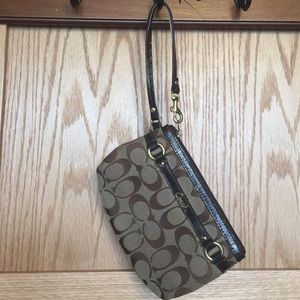 Never been used medium-sized, brown Coach wristlet