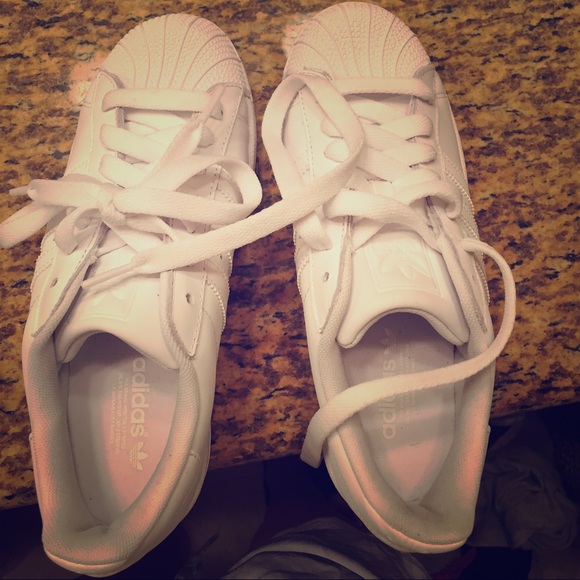 All white Adidas Superstar