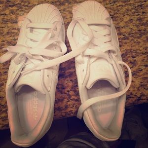All white Adidas Superstar