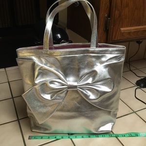 Authenticate spade metallic silver distressed bag.