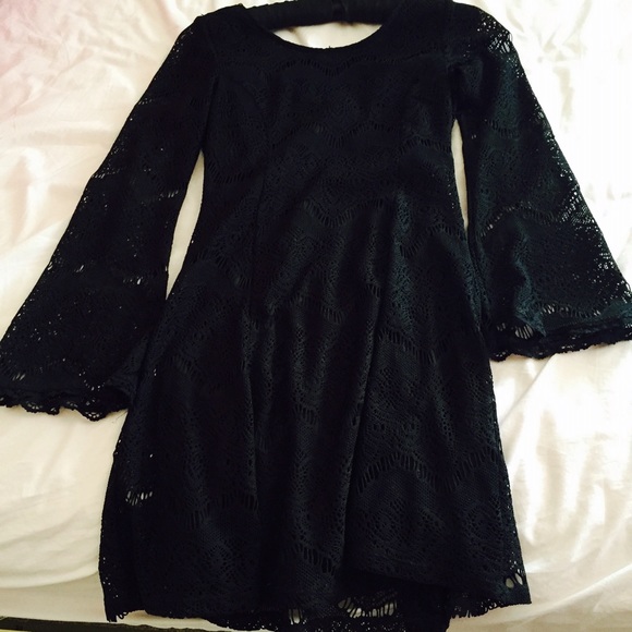 Lacy black bell-sleeve dress.