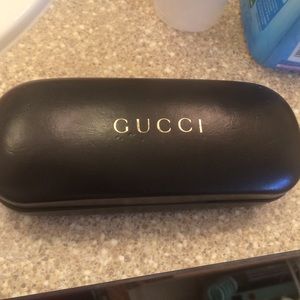 Gucci sunglasses case.