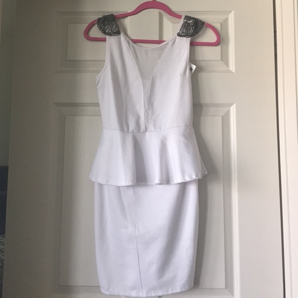 White peplum dress with plunging neckline