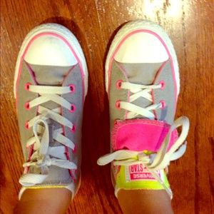 Pink, grey, and yellow converse sneakers.
