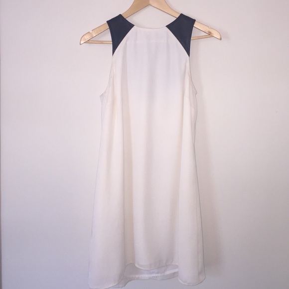 White shift dress with black leather detail