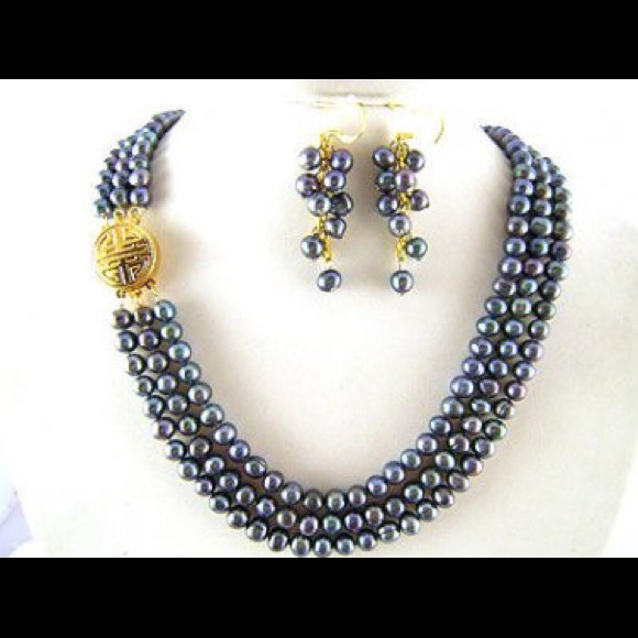 Triple strand grey pearls with embossed clasp.