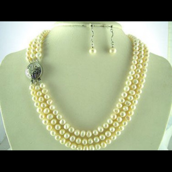 Triple strand pearls with embossed clasp