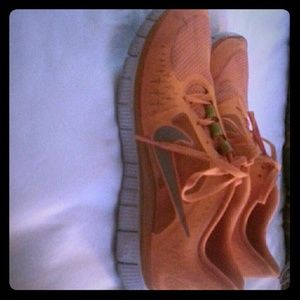 Orange nike free running shoes