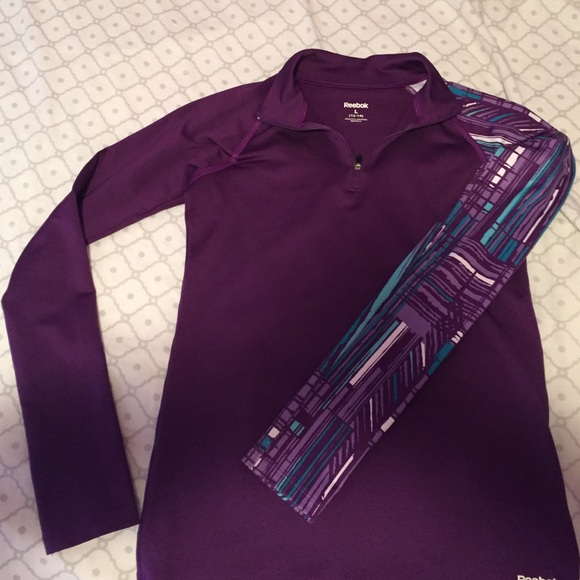 A half zip dark purple Reebok fitting sweatshirt