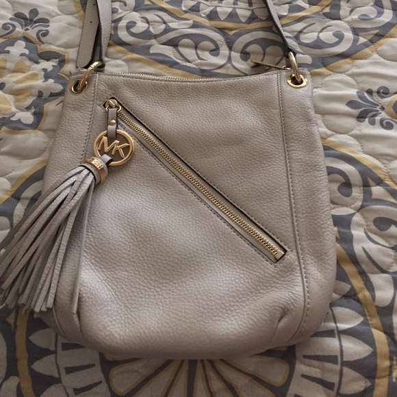 Michael Kors cream colored cross-body w/ tassel