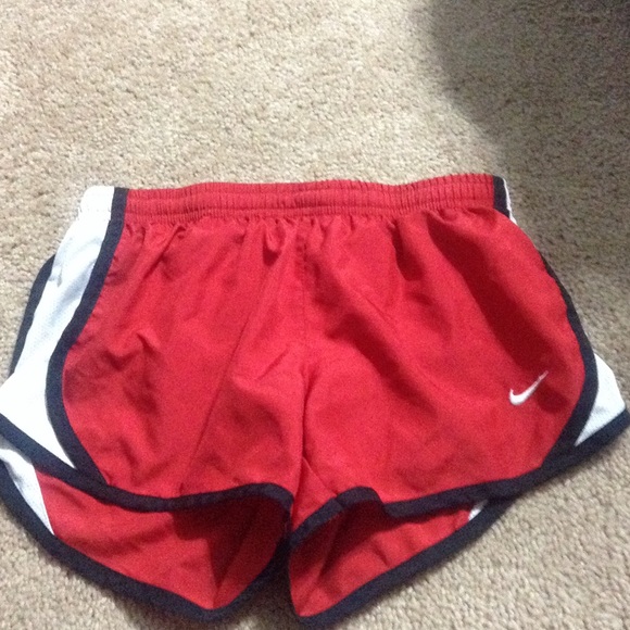 Size small red and white nike running shorts.