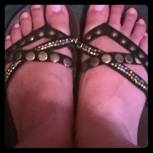 Brown sandals with gold jewels on the straps
