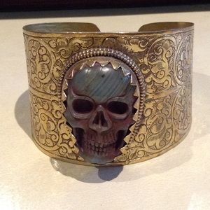 Carved labradorite skull, brass cuff bracelet.
