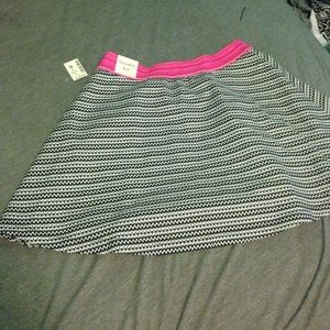 Black and white shirt with pink detail.