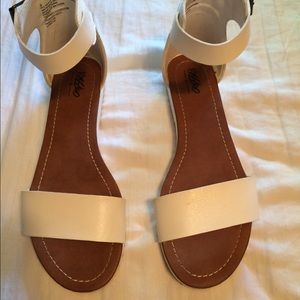 White faux leather strappy sandals.