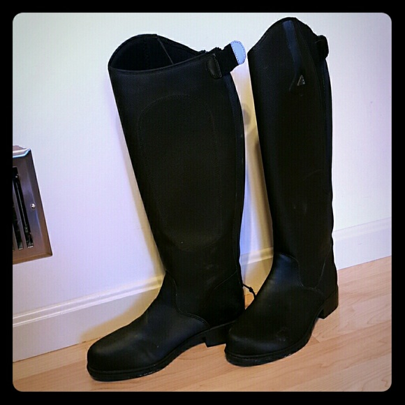 Tall winter riding boots and horse sculpture