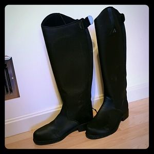 Tall winter riding boots and horse sculpture