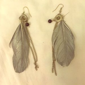Grey feathered earrings.