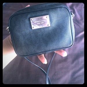 Michael Kords cross body black bag.