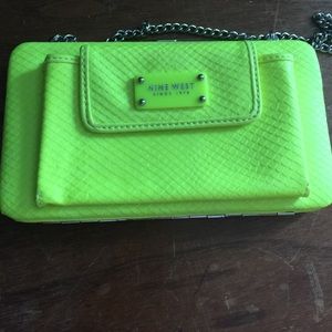 Neon yellow clutch with phone holder.