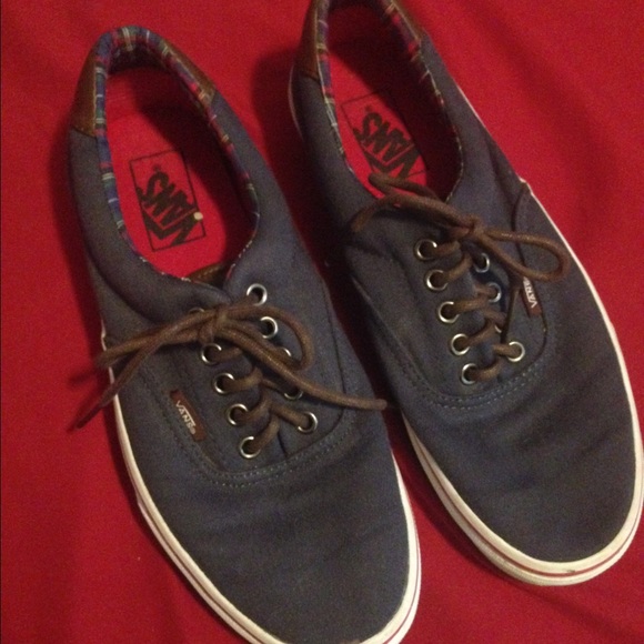 Navy blue Vans with a canvas patch on heel