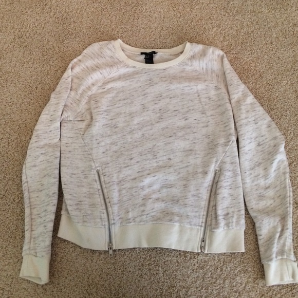 cream colored sweater with two side zippers