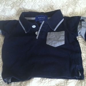 Two baby boy polo shirts with anchor buttons.