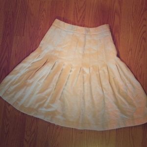 Cream pleated knee length skirt