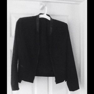 A black jacket with elegant leather trim in front.
