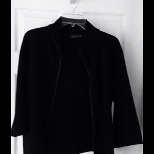 A light knit jacket in black with leather trim.