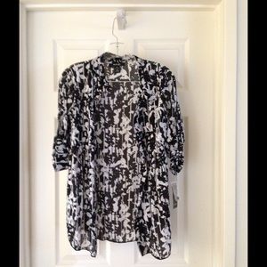 A black and white floral mid-length blouse.