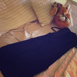 Sleeveless, long, black knitted cardigan.
