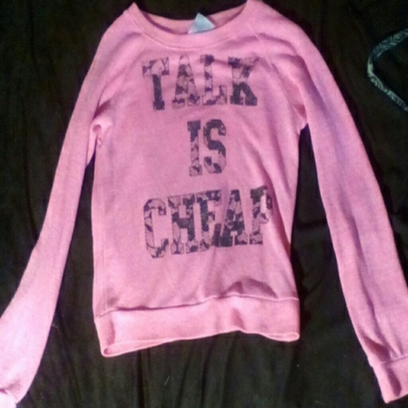 Pink "Talk is Cheap" sweater.