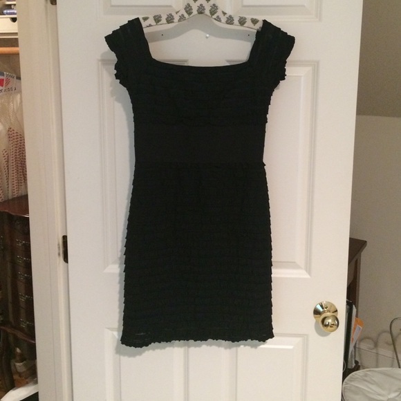 Fitted black dress with ruffled texture.