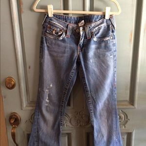 Medium denim, distressed True Religion jeans