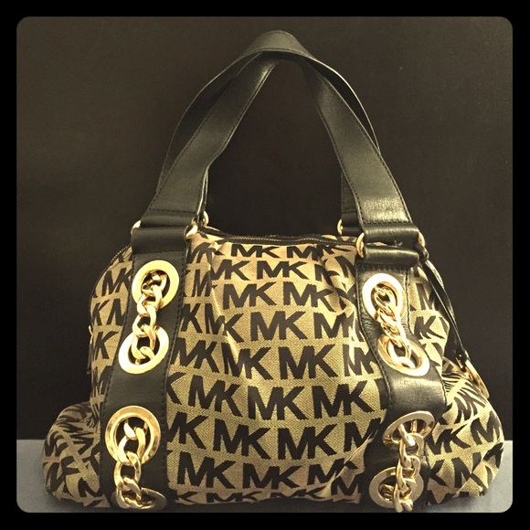 Black Michael Kors purse with golden accents