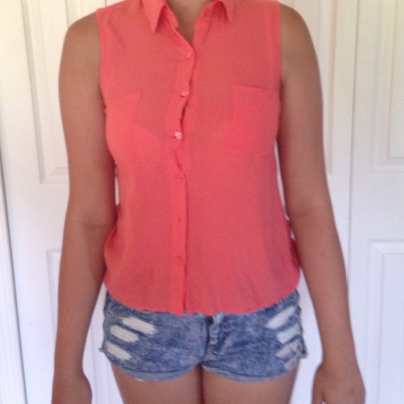 A coral, sleeveless button up tank top.
