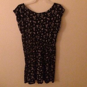 Short black dress with white flowers.