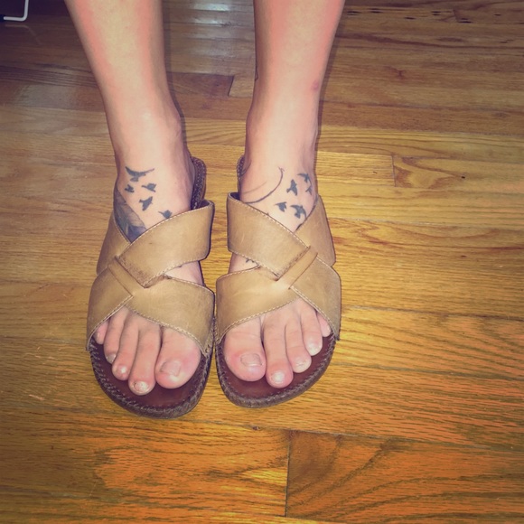 Light brown backless sandals with slight wedge