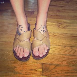 Light brown backless sandals with slight wedge