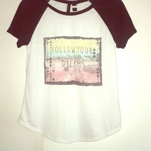 A white t-shirt with a pastel graphic on the front