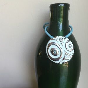 Light blue and silver colored pendant