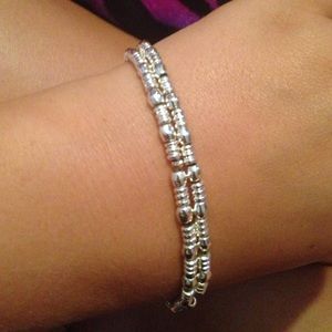 Two silver beaded bracelets.