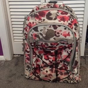 Kipling transforming book bag to suitcase!