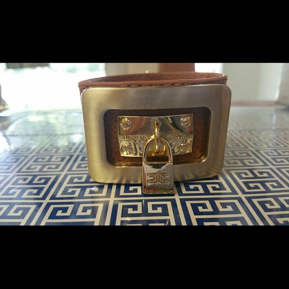 Faux leather 3 snap cuff with gold buckle and lock