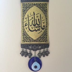 Handmade evil eye w arabic writing on rug Handmade evil eye w arabic writing on rug