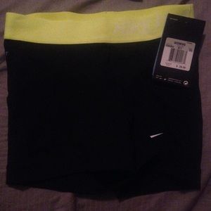 Black Nike pros with neon yellow waist.