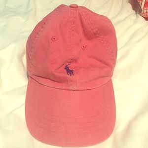 faded red, almost pink colored polo hat